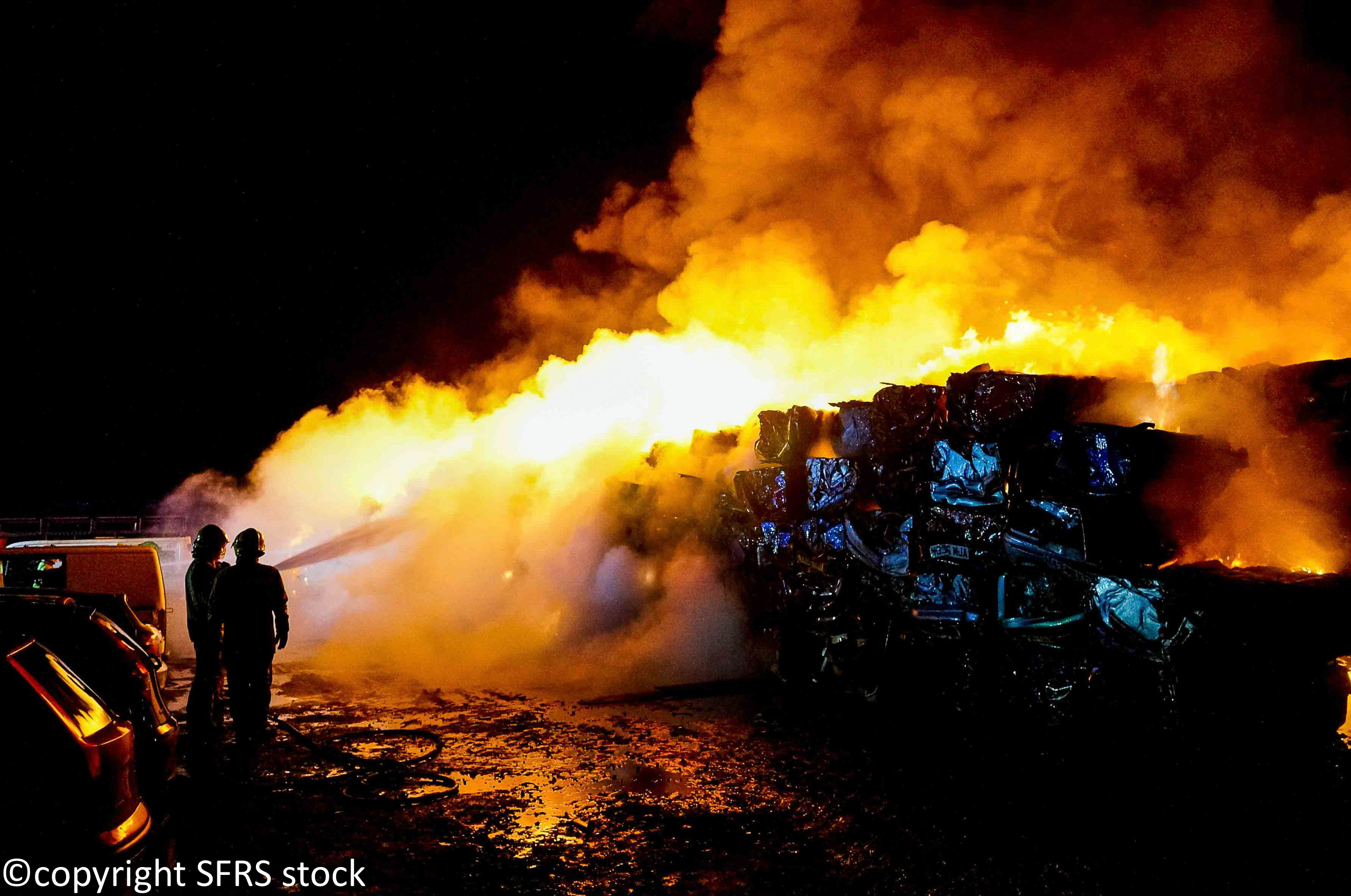 Firefighters hosing down flames