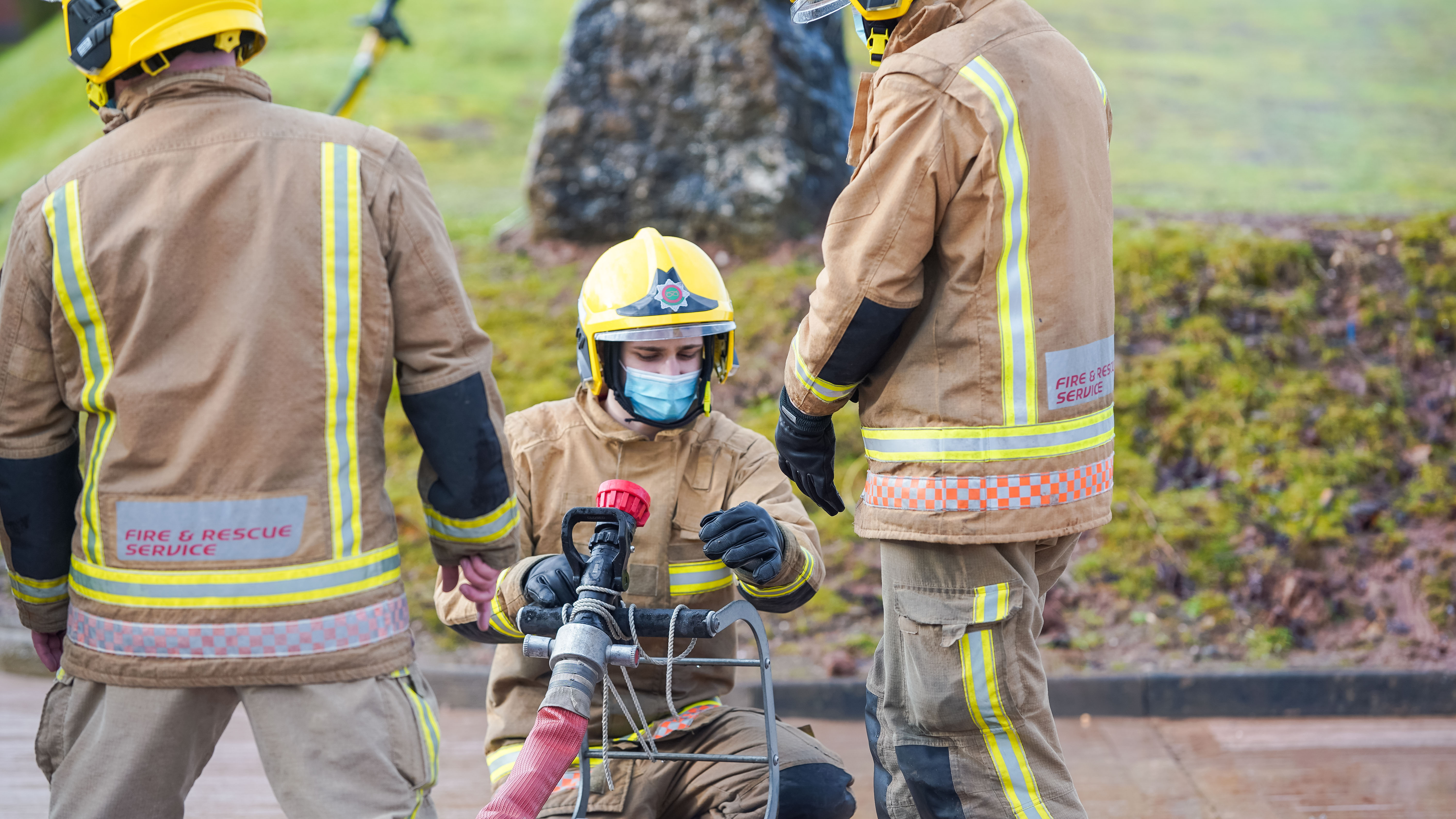 Firefighter operating hose