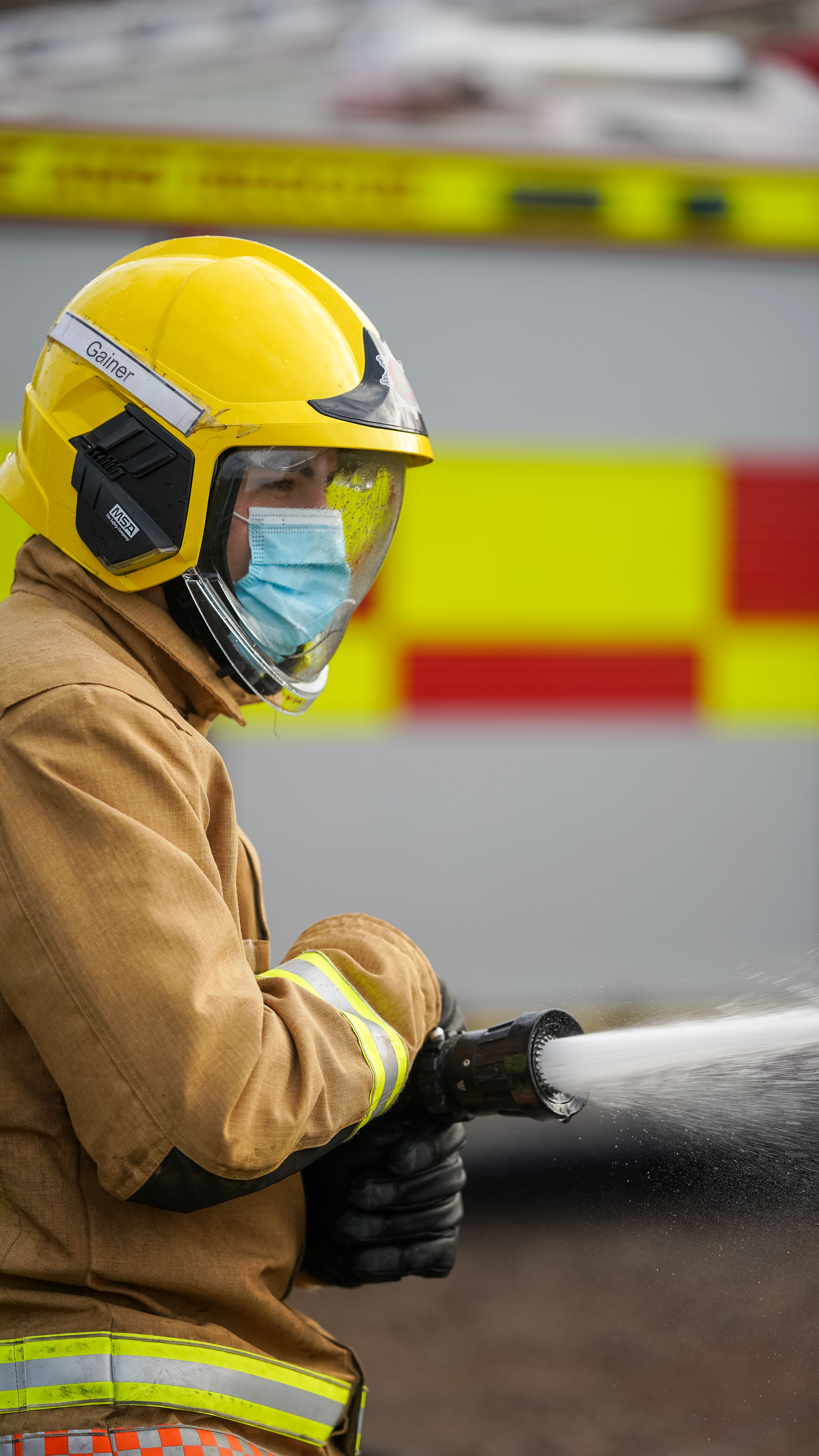 Firefighter using hose