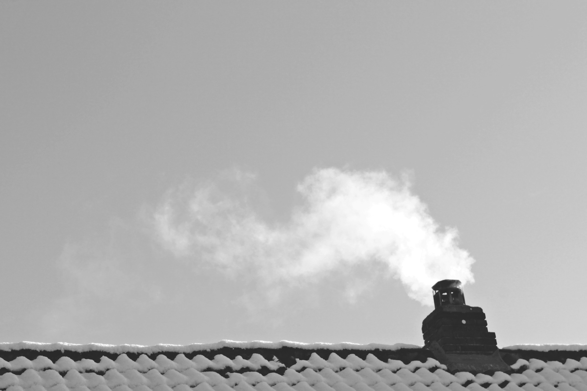 Rooftop chimney billowing smoke