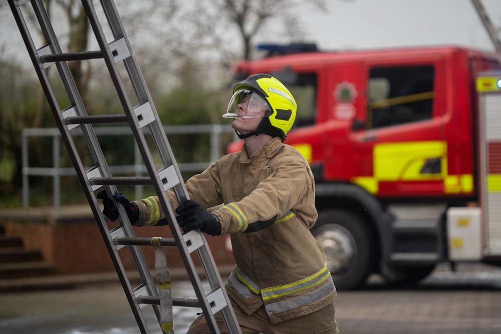 Firefighter climbing ladder